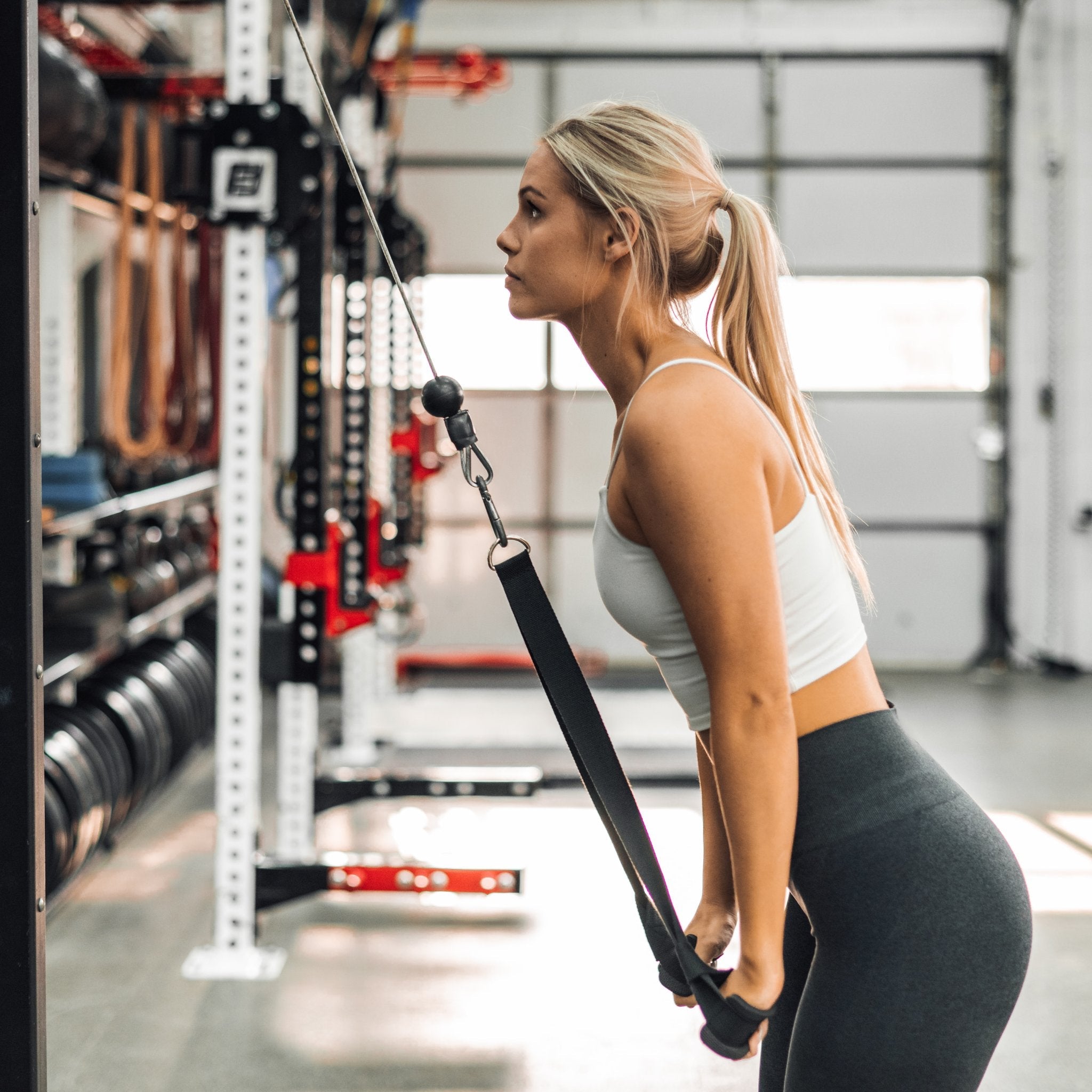 A Woman Using The Reverse Squat Strap  Created By The Tib Bar Guy