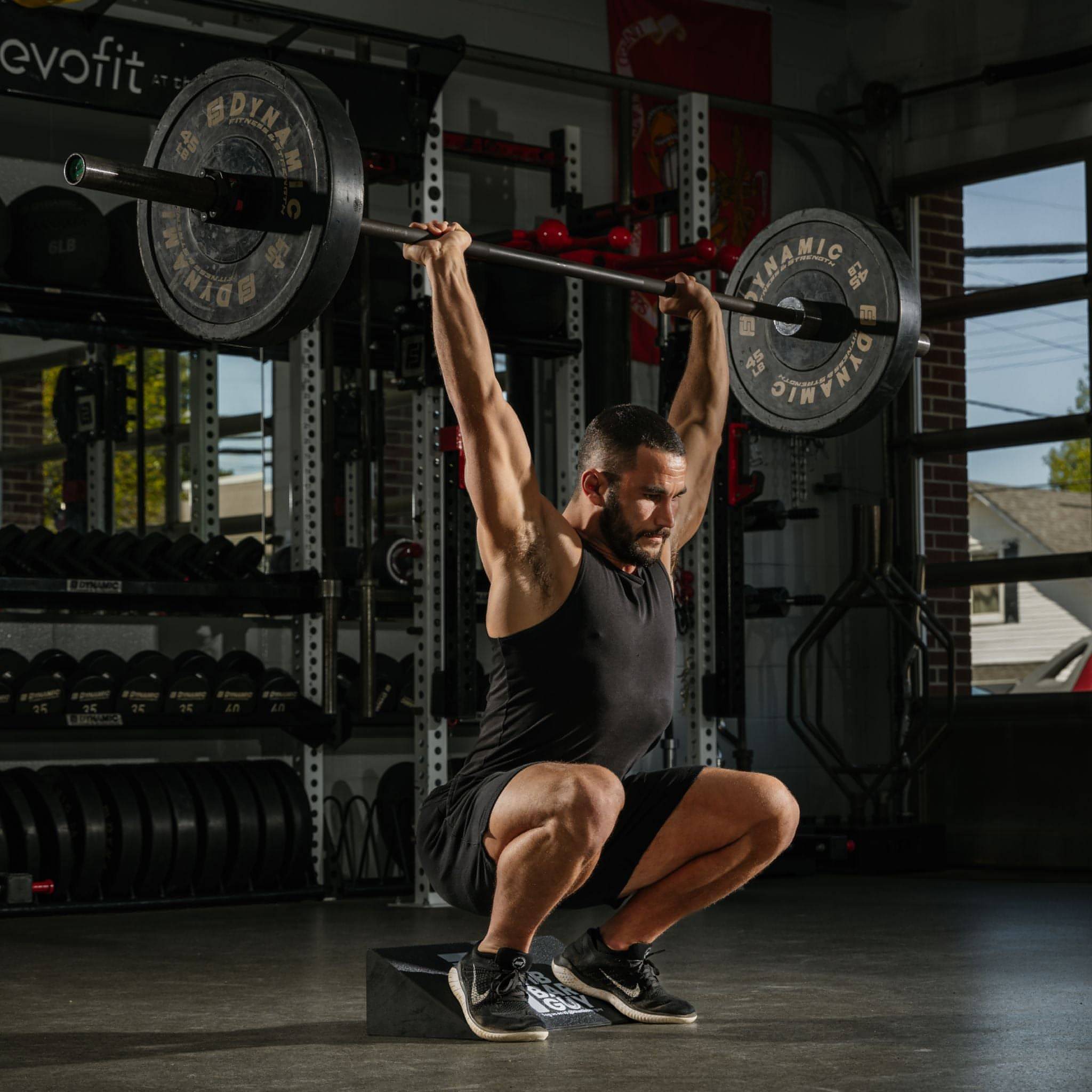 A Man Doing Deadlifts With a Slant Board Created By The Tib Bar Guy